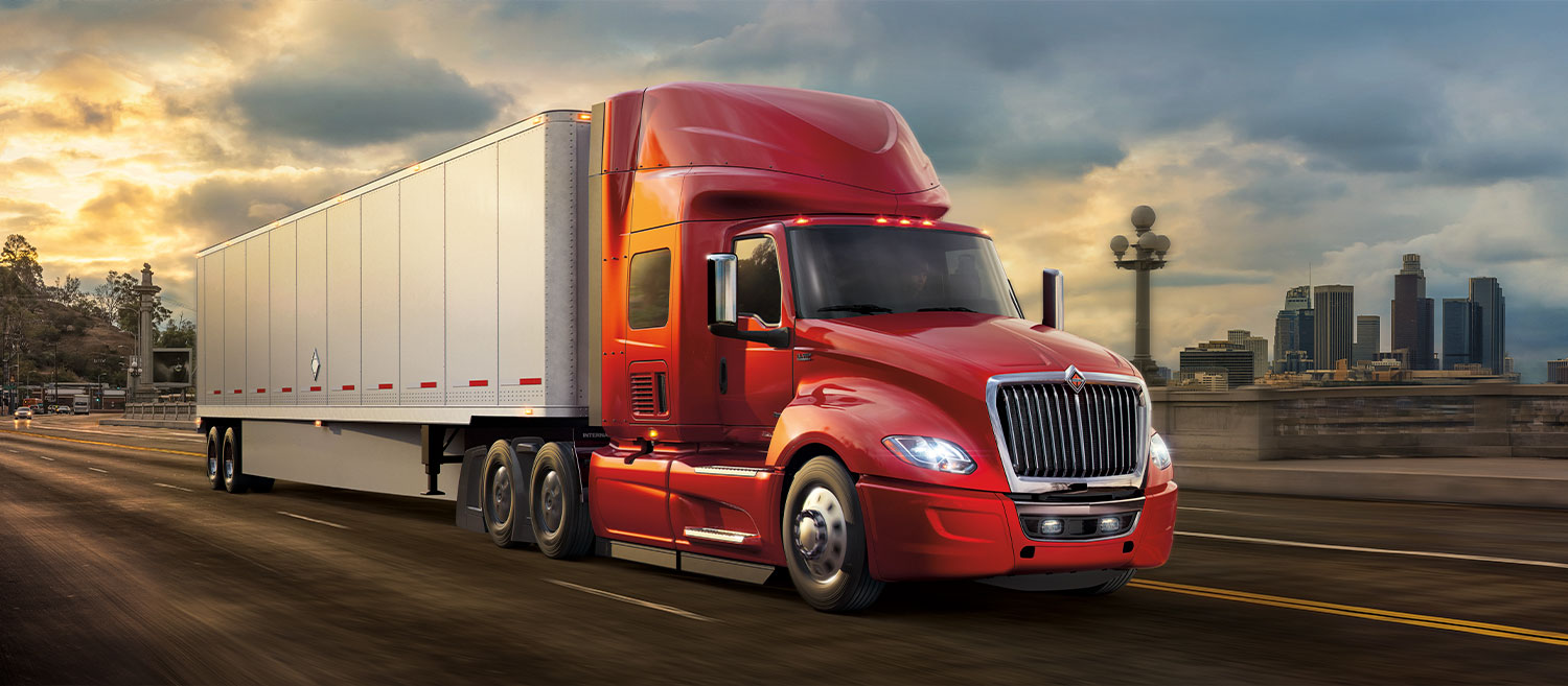 Blue 2020 International® CV™ Series medium duty truck driving down a road.